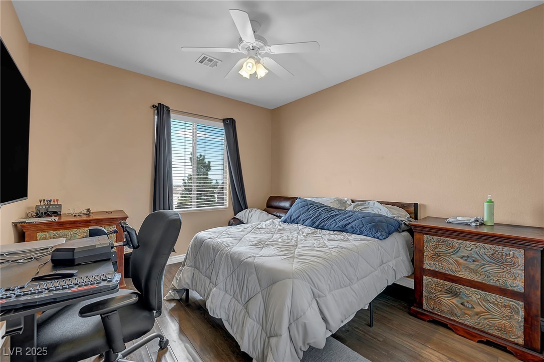 8208 Seven Falls Street North Las Vegas, NV 89085 - Photo 41 of 69 Bedroom featuring wood finished floors and ceiling fan