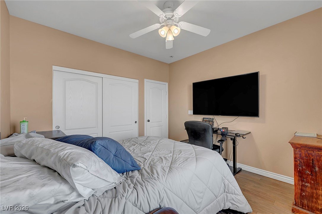 8208 Seven Falls Street North Las Vegas, NV 89085 - Photo 42 of 69 Bedroom with light wood-style floors, a closet, and ceiling fan