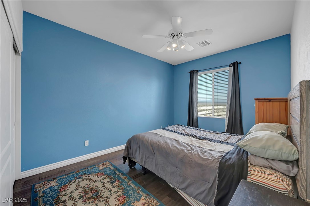 8208 Seven Falls Street North Las Vegas, NV 89085 - Photo 44 of 69 Bedroom featuring wood finished floors and ceiling fan