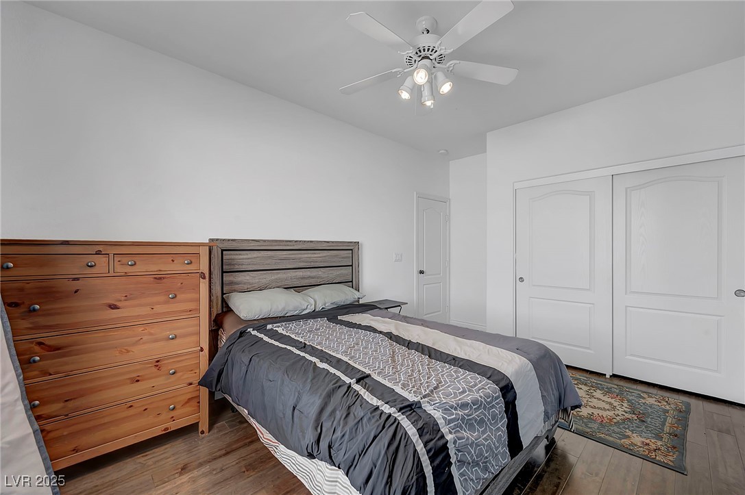8208 Seven Falls Street North Las Vegas, NV 89085 - Photo 45 of 69 Bedroom featuring wood finished floors, a closet, and a ceiling fan