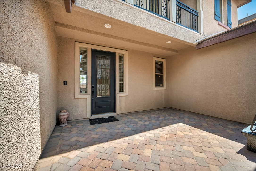 8208 Seven Falls Street North Las Vegas, NV 89085 - Photo 49 of 69 Entrance to property featuring stucco siding and a patio area