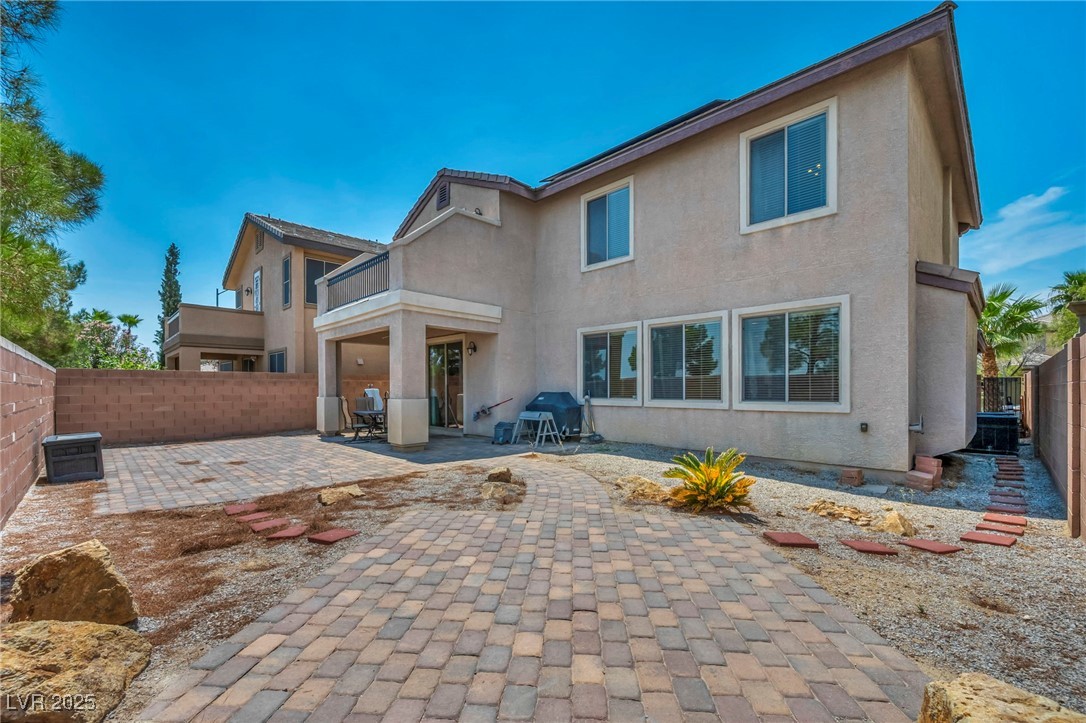 8208 Seven Falls Street North Las Vegas, NV 89085 - Photo 66 of 69 Back of house with a patio area, stucco siding, a fenced backyard, and a balcony