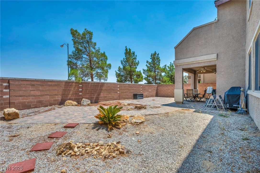 8208 Seven Falls Street North Las Vegas, NV 89085 - Photo 67 of 69 Fenced backyard with a patio and ceiling fan