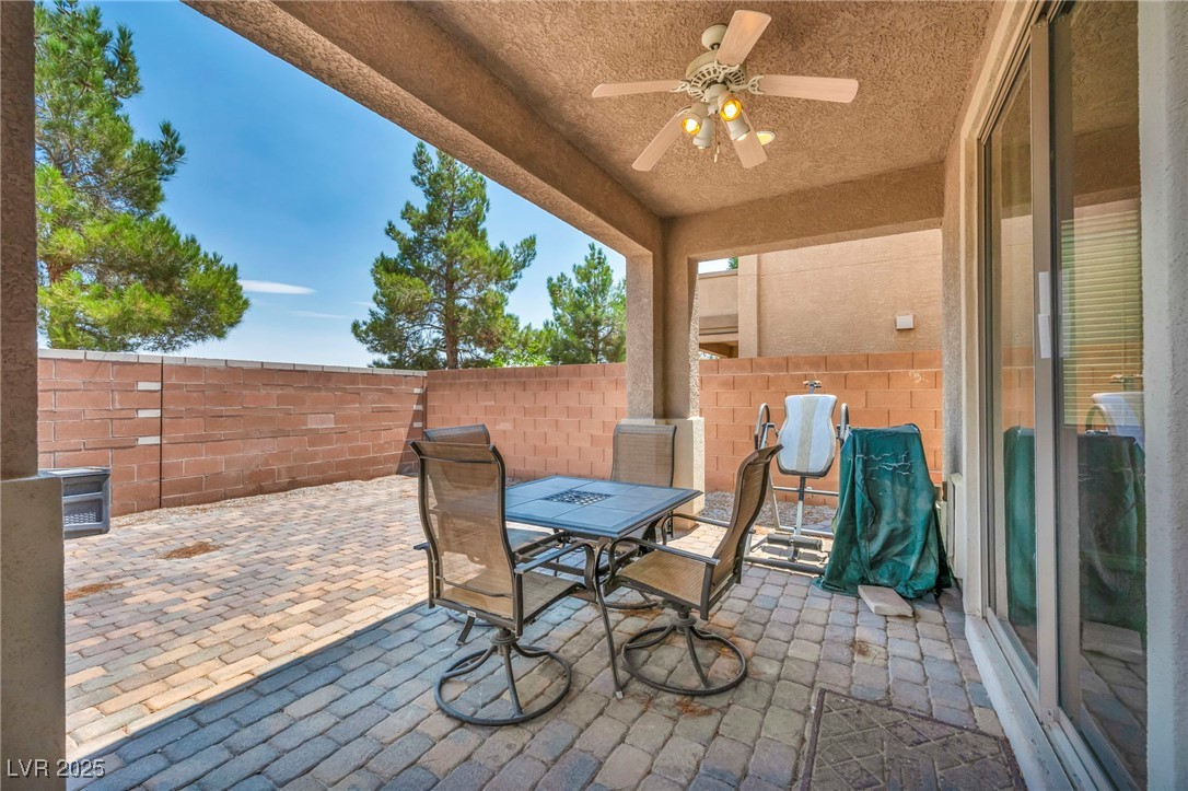 8208 Seven Falls Street North Las Vegas, NV 89085 - Photo 68 of 69 Fenced backyard with outdoor dining area, a patio area, and ceiling fan