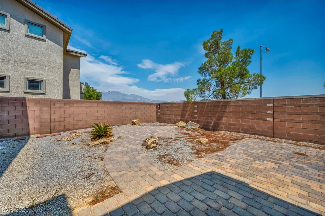 8208 Seven Falls Street North Las Vegas, NV 89085 - Photo 69 of 69 Fenced backyard featuring a mountain view and a patio