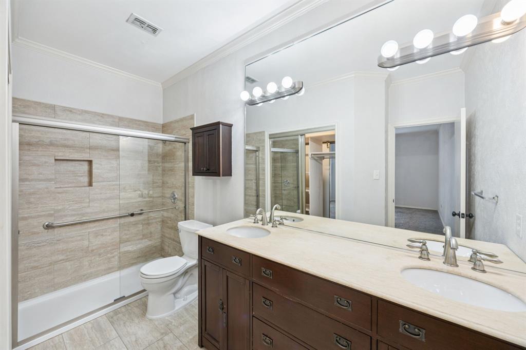 5310 Keller Springs Road, Unit 221 Dallas, TX 75248 - Photo 16 of 29 a bathroom with a double vanity sink toilet and shower