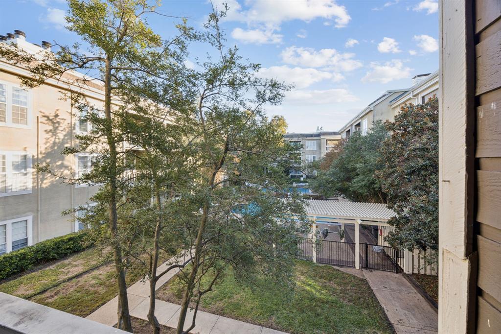 5310 Keller Springs Road, Unit 221 Dallas, TX 75248 - Photo 24 of 29 a view of a terrace with a bench and trees