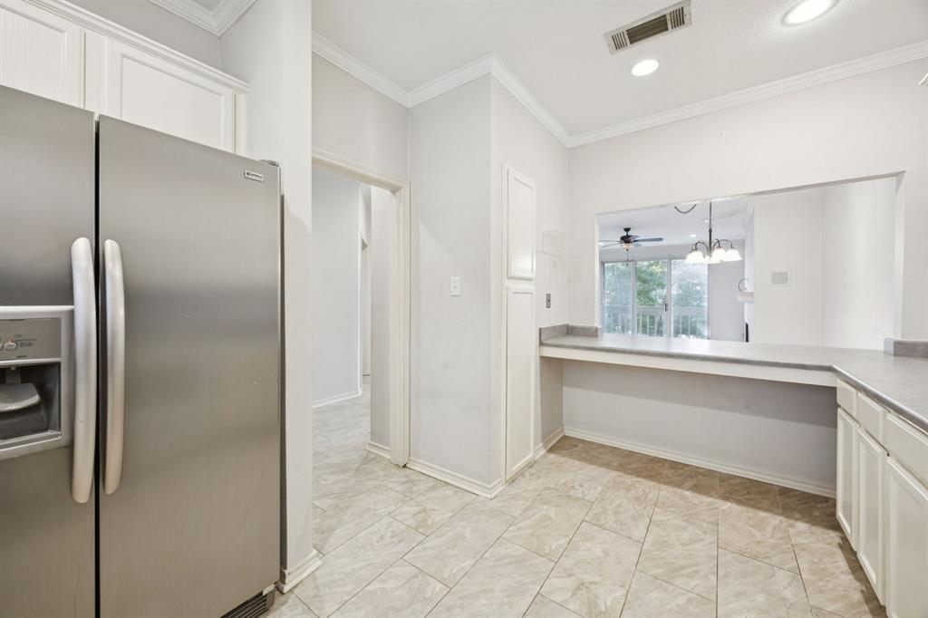 5310 Keller Springs Road, Unit 221 Dallas, TX 75248 - Photo 4 of 29 a view of kitchen with refrigerator and window