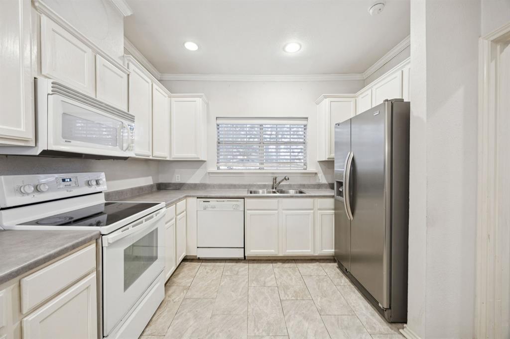 5310 Keller Springs Road, Unit 221 Dallas, TX 75248 - Photo 5 of 29 a kitchen with stainless steel appliances granite countertop a refrigerator and a stove top oven