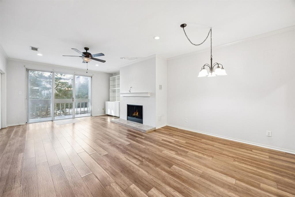 5310 Keller Springs Road, Unit 221 Dallas, TX 75248 - Photo 7 of 29 a view of empty room with wooden floor and fan