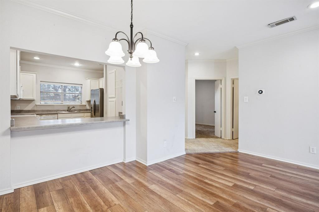 5310 Keller Springs Road, Unit 221 Dallas, TX 75248 - Photo 9 of 29 a view of a kitchen and a chandelier wooden floor and a kitchen space