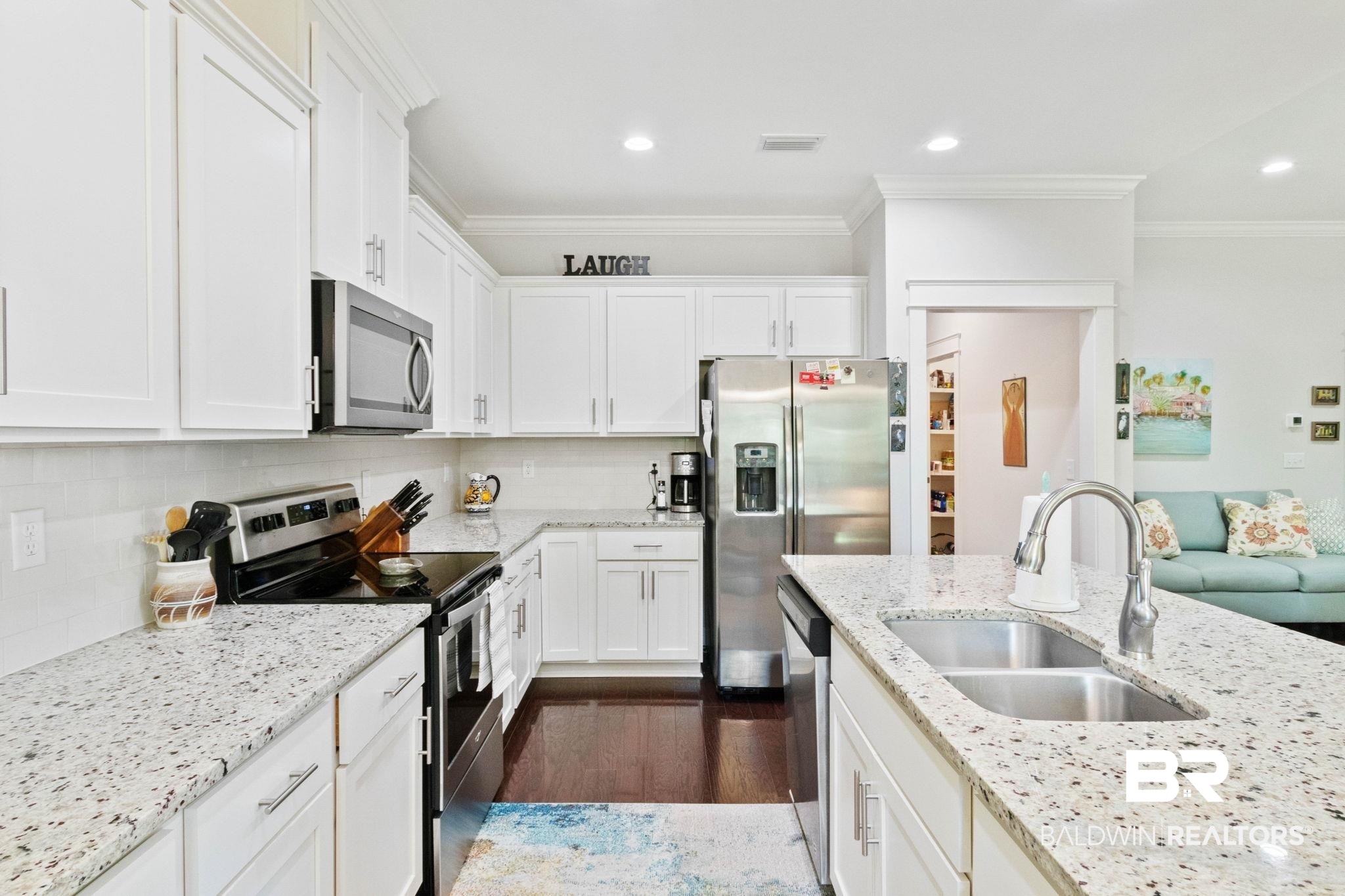 192 Mark Twain Loop Foley, AL 36535 - Photo 18 of 42 Kitchen with tasteful backsplash, dark hardwood / wood-style flooring, appliances with stainless steel finishes, sink, and ornamental molding