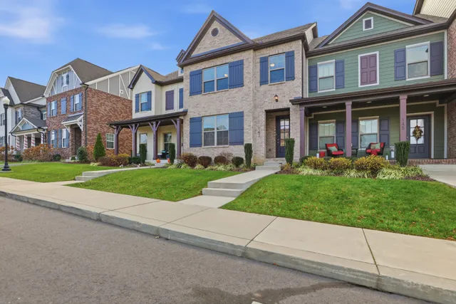 front view of a brick house with a yard
