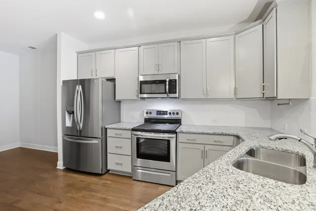 a kitchen with a sink stove and refrigerator
