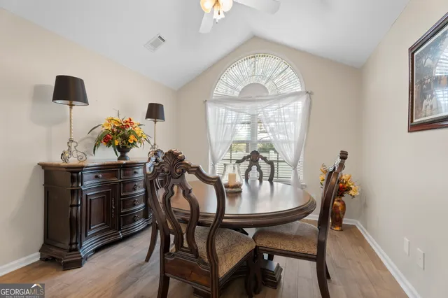 a view of a dining room with furniture and chandelier