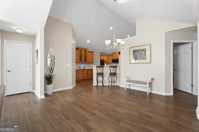 a view of a kitchen with furniture and wooden floor