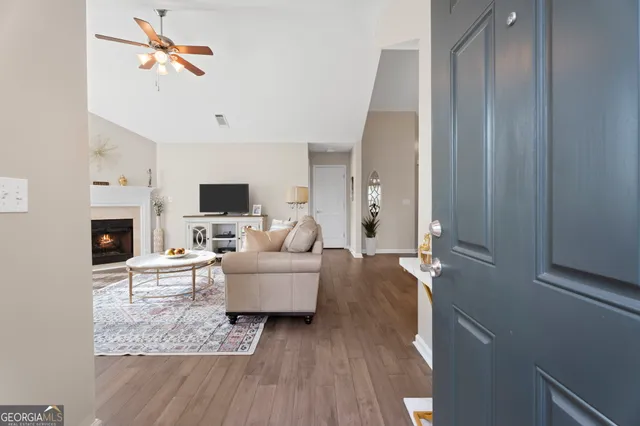 a living room with furniture a fireplace and a flat screen tv