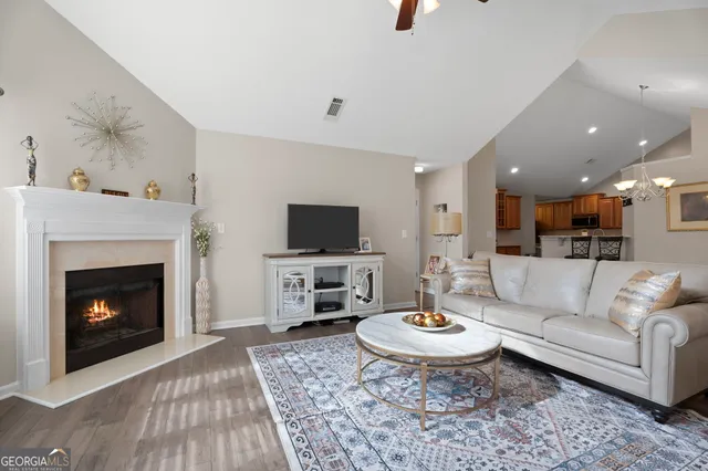 a living room with furniture and a fireplace