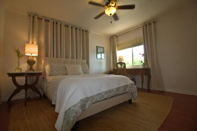 a spacious bedroom with a bed and a window