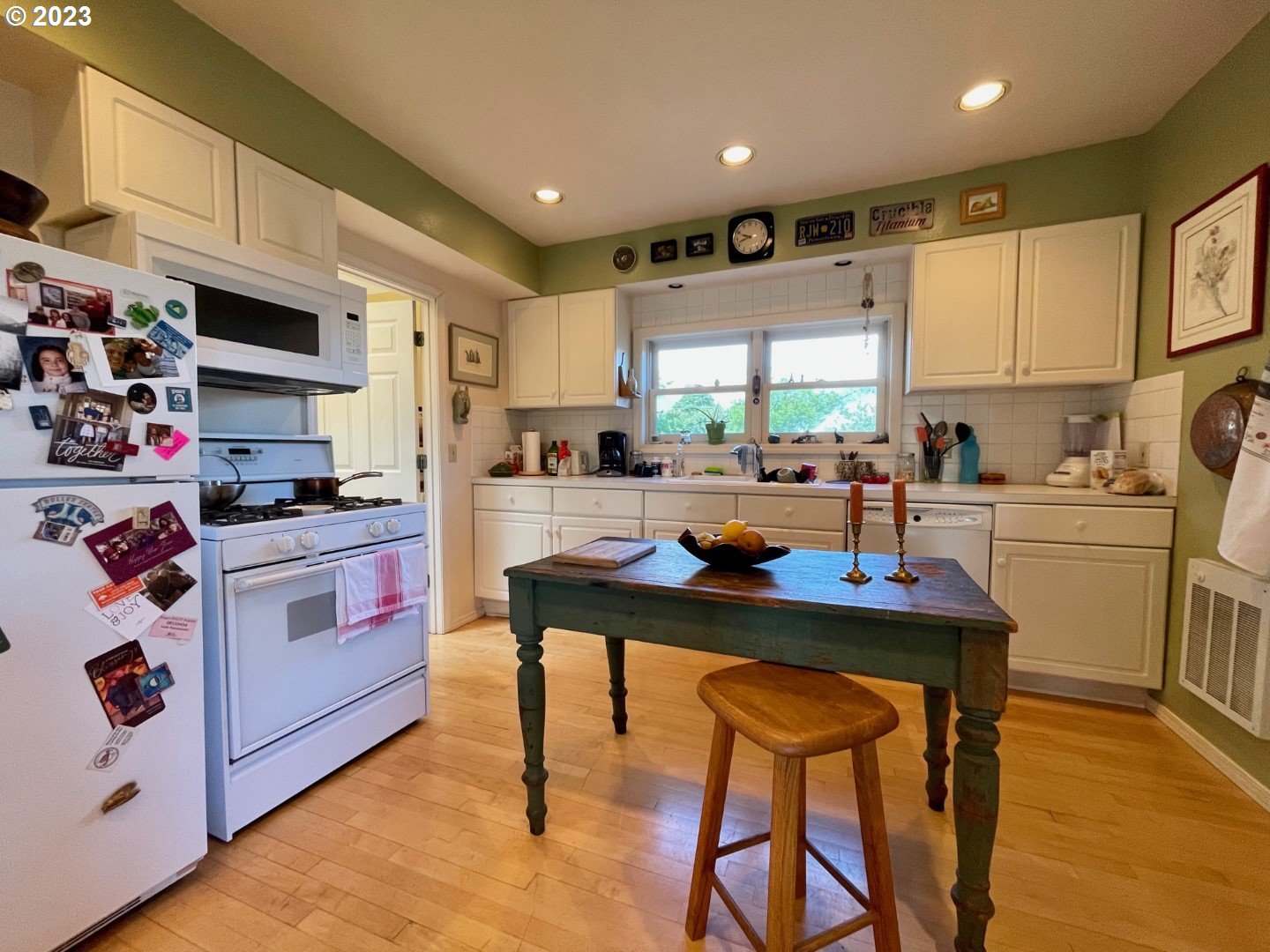 809 South Lake Street Joseph, OR 97846 - Photo 13 of 38 a kitchen with stainless steel appliances kitchen island granite countertop a table chairs sink and cabinets