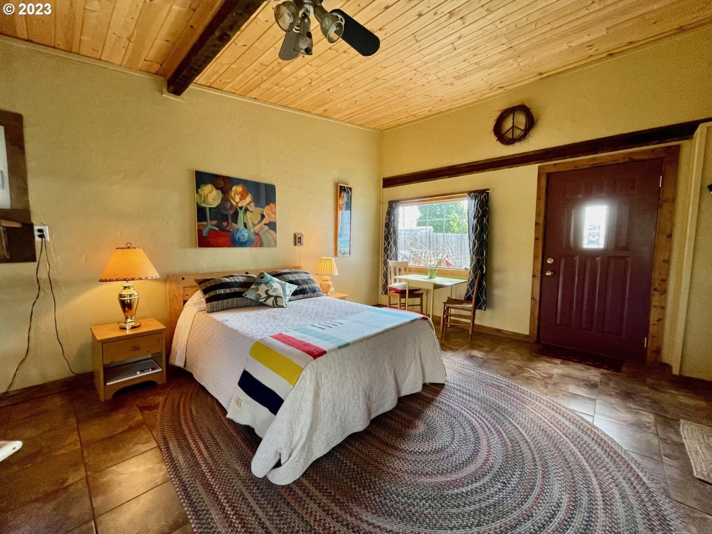 809 South Lake Street Joseph, OR 97846 - Photo 23 of 38 a spacious bedroom with a bed and a chandelier