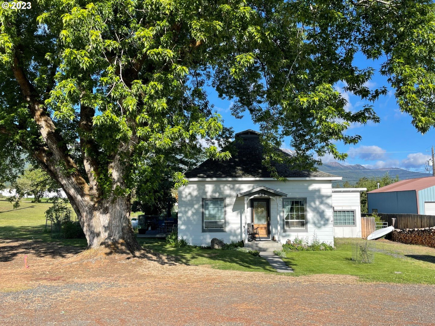 809 South Lake Street Joseph, OR 97846 - Photo 3 of 38 a front view of a house with a garden and tree