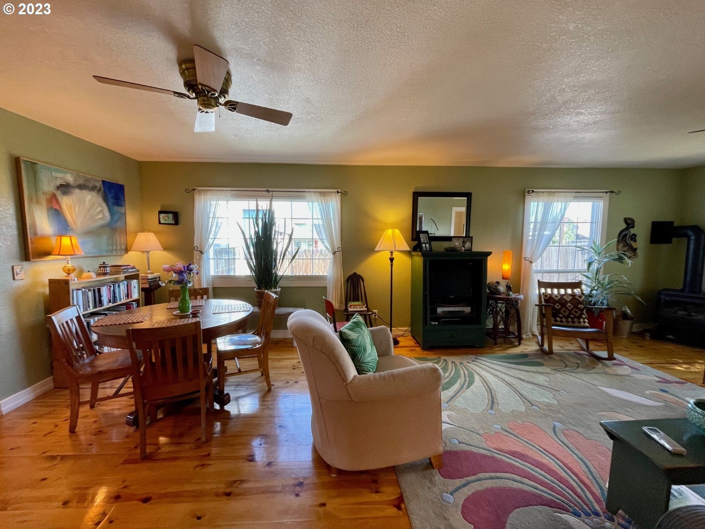 809 South Lake Street Joseph, OR 97846 - Photo 9 of 38 a living room with furniture a dining table and paintings on the wall