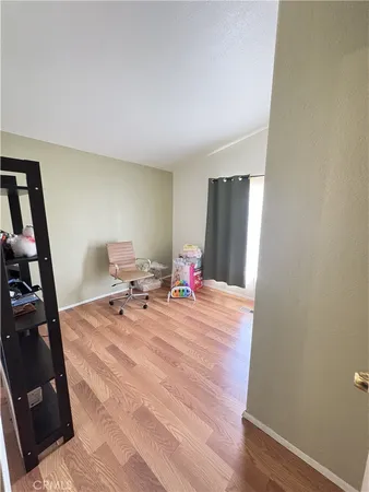 a room with wooden floor and furniture