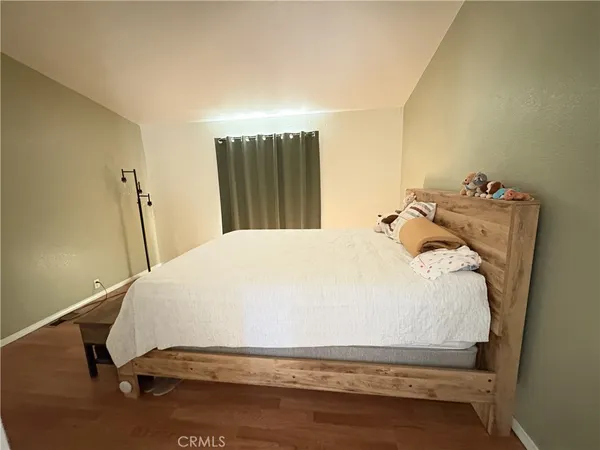 a bedroom with a bed and a dresser