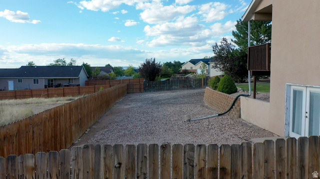 1797 Sunset Road Enoch, UT 84721 - Photo 58 of 80 Expansive gravel-covered yard with a new wood privacy fence