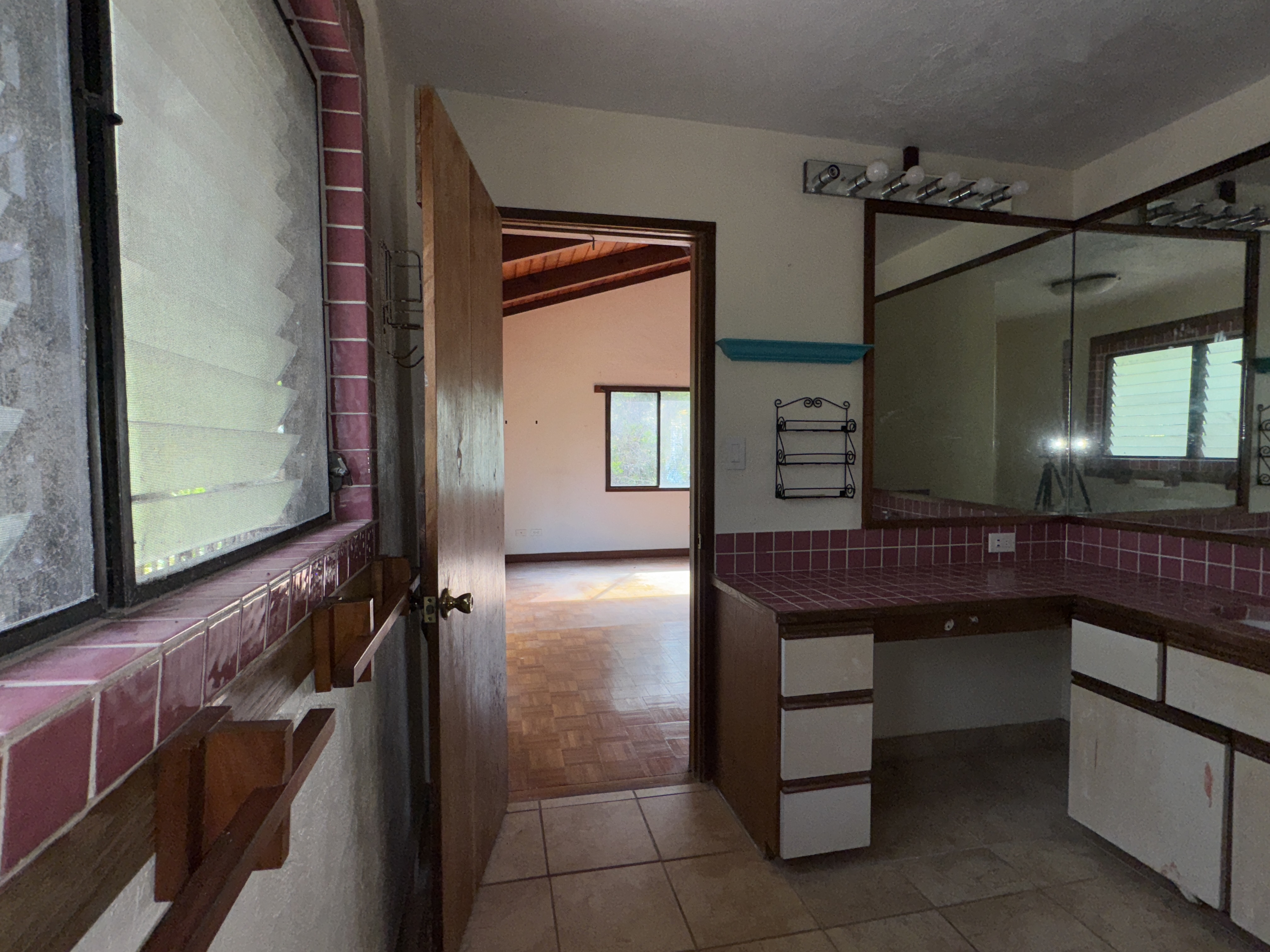 84-5040 Hawaiʻi Belt Road Captain Cook, HI 96704 - Photo 22 of 30 a bathroom with a sink a toilet and mirror