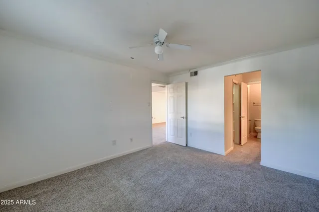 a bathroom with a granite countertop double vanity and a mirror