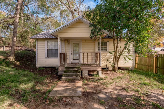 a backyard of a house with yard and outdoor seating