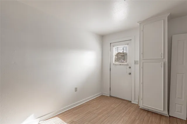 a view of an empty room and wooden floor