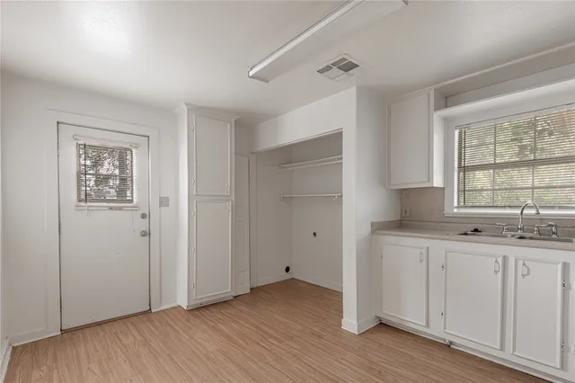 a view of a kitchen with wooden floor and window