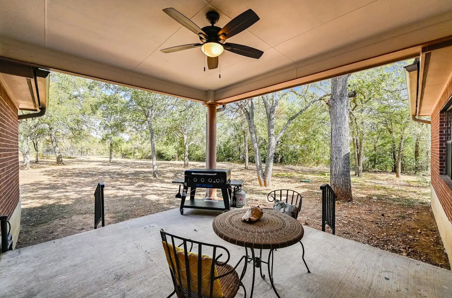 486 Westwood Road Lockhart, TX 78644 - Photo 20 of 29 View of large back patio featuring ceiling fan, shade trees nearby, room for grill & entertaining family & friends