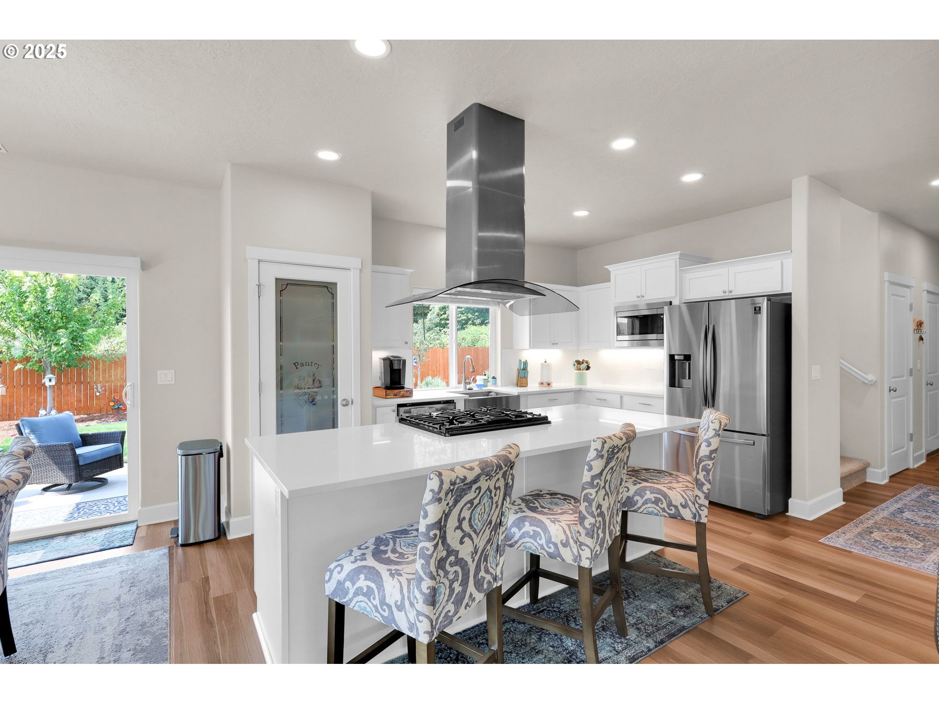 580 South 10th Street Monroe, OR 97456 - Photo 13 of 45 a kitchen with stainless steel appliances kitchen island granite countertop a dining table chairs and white cabinets