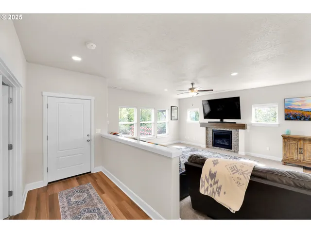 a view of living room kitchen with furniture and flat screen tv