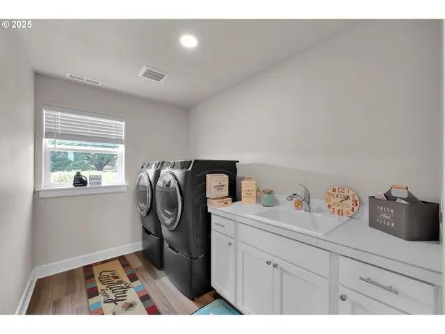 a utility room with sink dryer and washer