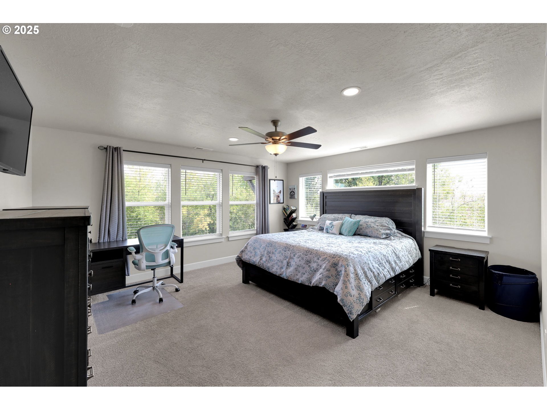 580 South 10th Street Monroe, OR 97456 - Photo 34 of 45 a spacious bedroom with a bed a table and large window