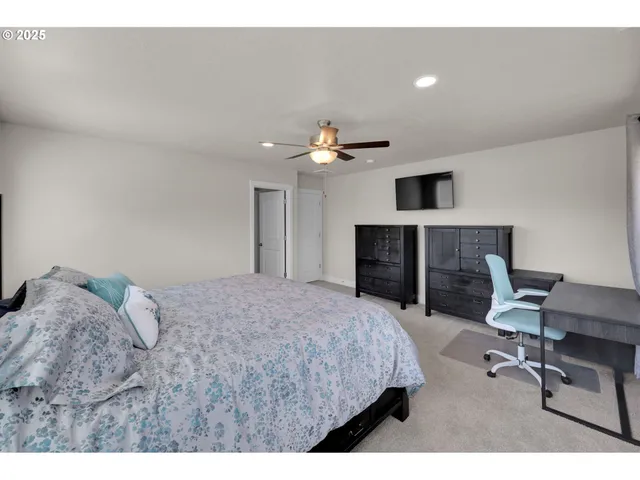 a bed room with a bed and a chair