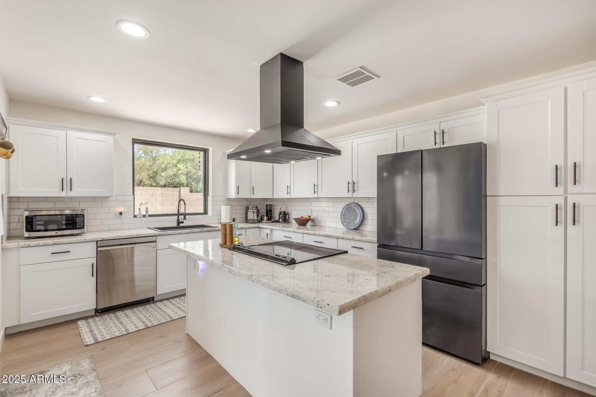226 East McKinley Street Tempe, AZ 85288 - Photo 9 of 36 a kitchen with white cabinets and stainless steel appliances