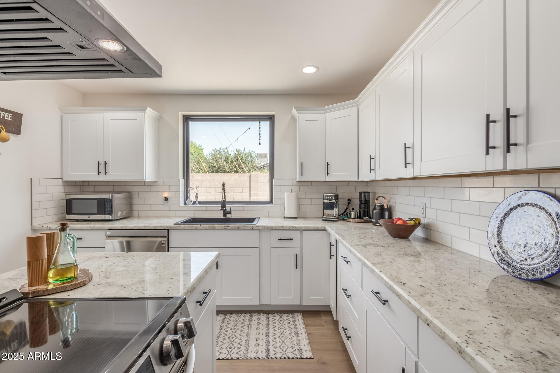 226 East McKinley Street Tempe, AZ 85288 - Photo 12 of 36 a kitchen with a sink a stove cabinets and a window
