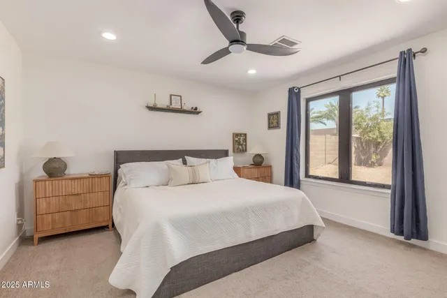 a kitchen with a sink appliances cabinets and a large window