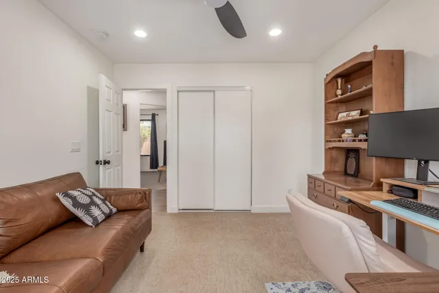 a large bed sitting in a bedroom next to a window