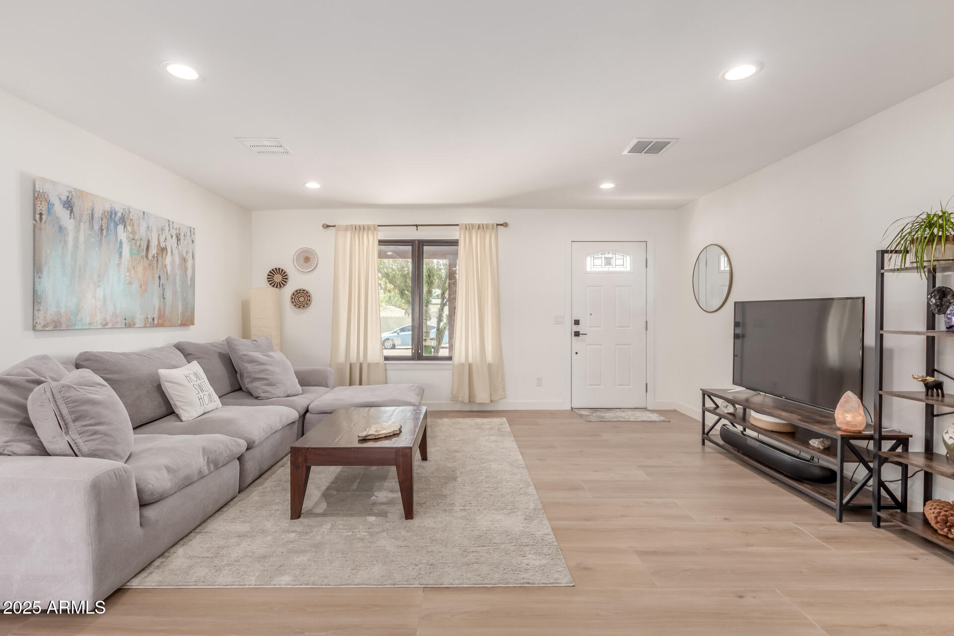 226 East McKinley Street Tempe, AZ 85288 - Photo 3 of 36 a living room with furniture a dining table and a flat screen tv
