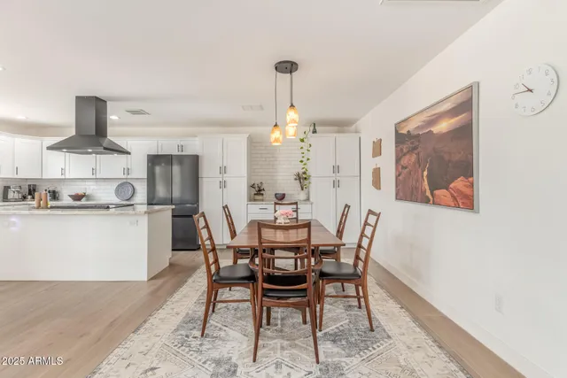 a kitchen with stainless steel appliances kitchen island granite top and refrigerator
