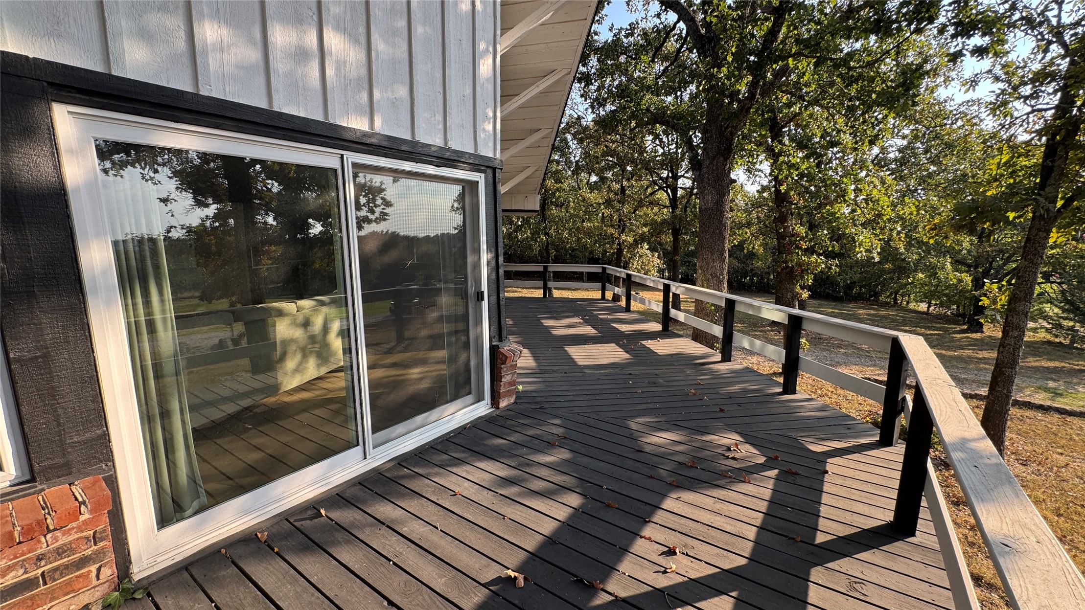 96358 South 4531 Road Vian, OK 74962 - Photo 39 of 58 Spacious outdoor deck with a wood-finish surface, composite railing, and surrounding mature trees
