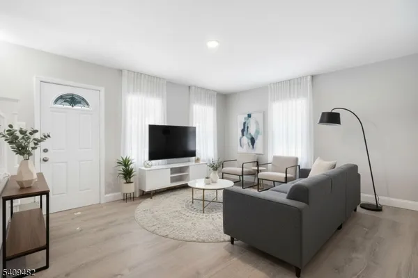 a bedroom with a large bed and a painting on the wall