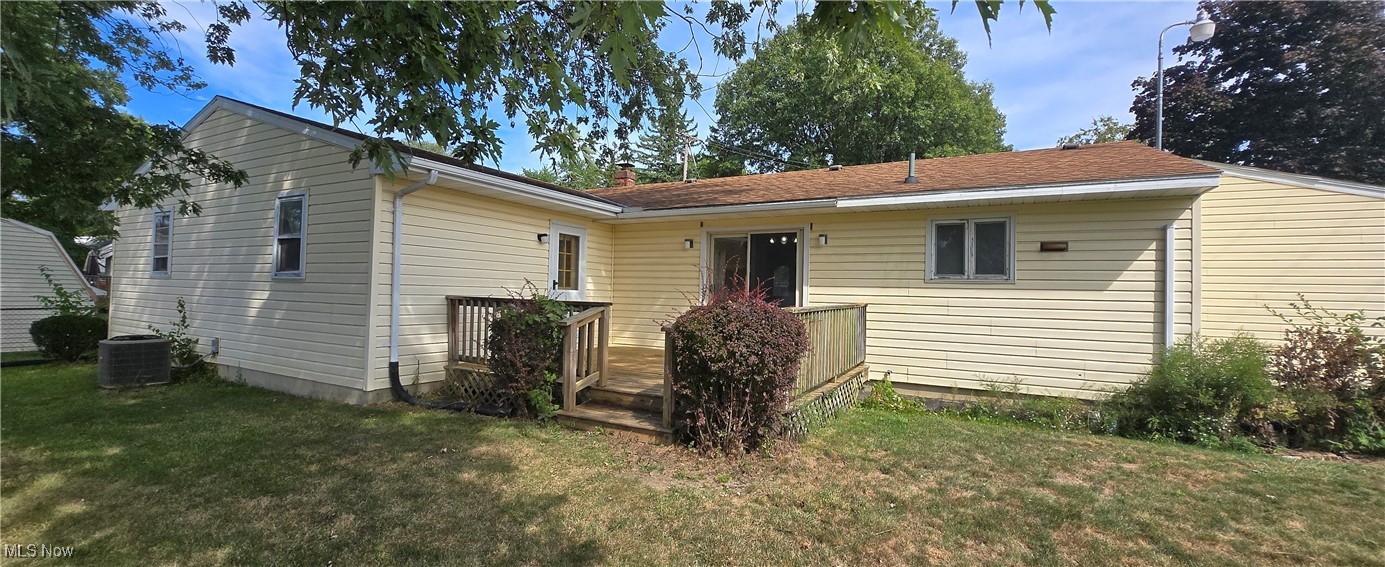 321 Magnolia Road Huron, OH 44839 - Photo 3 of 23 Back of property with central AC and a yard